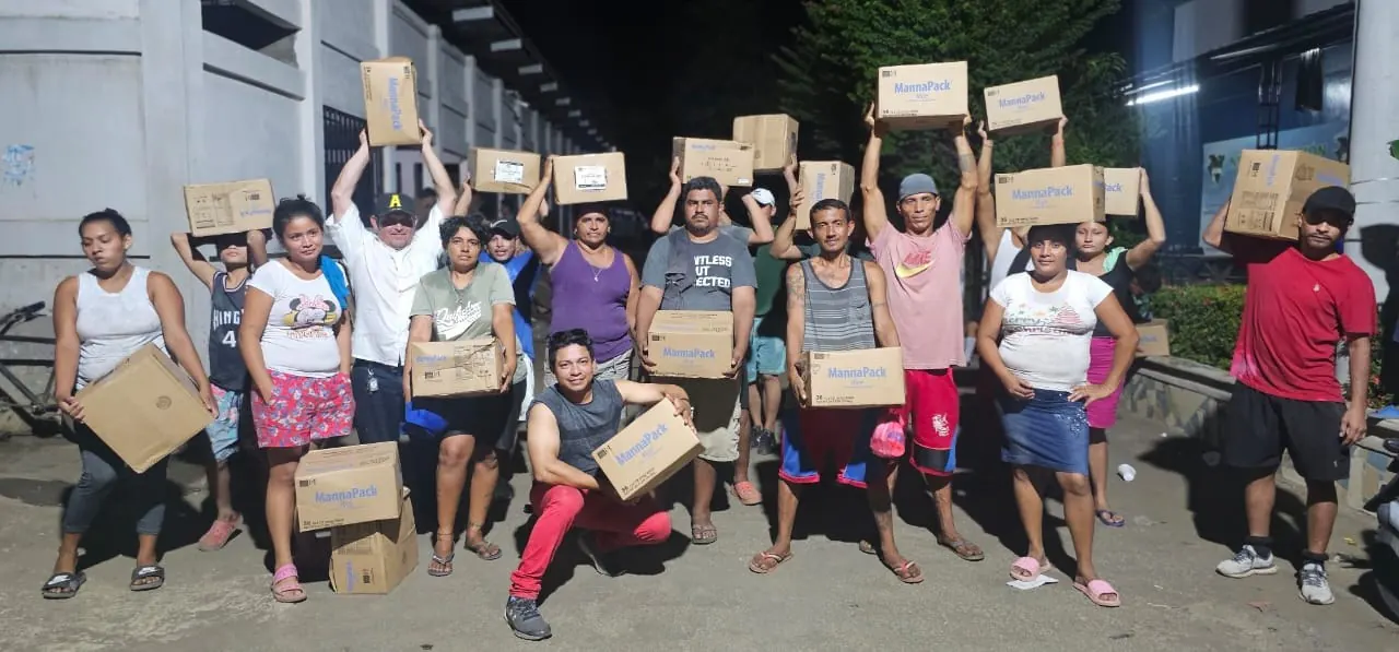 Volunteers carrying MannaPack Rice boxes for feeding programs in Nicaragua